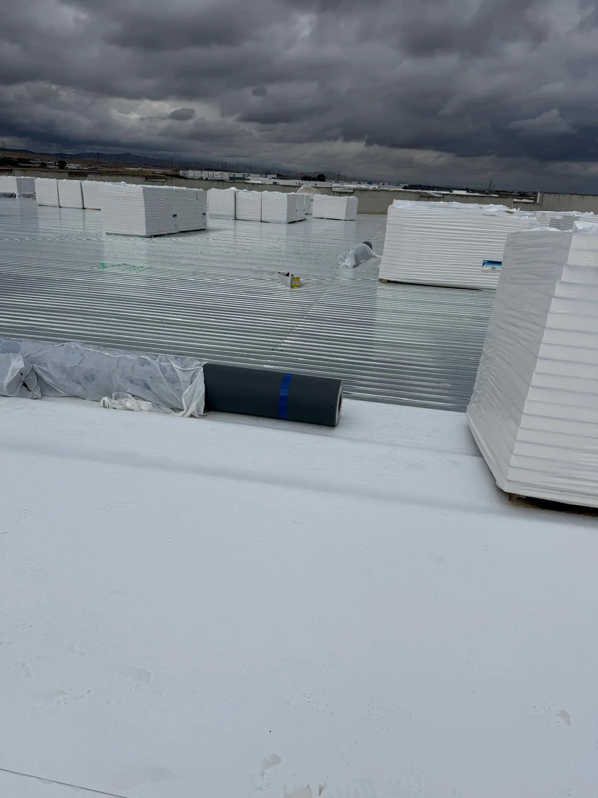 Commercial roof under storm clouds