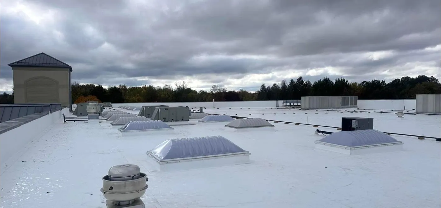 Completed white commercial roofing system by King George Roofing